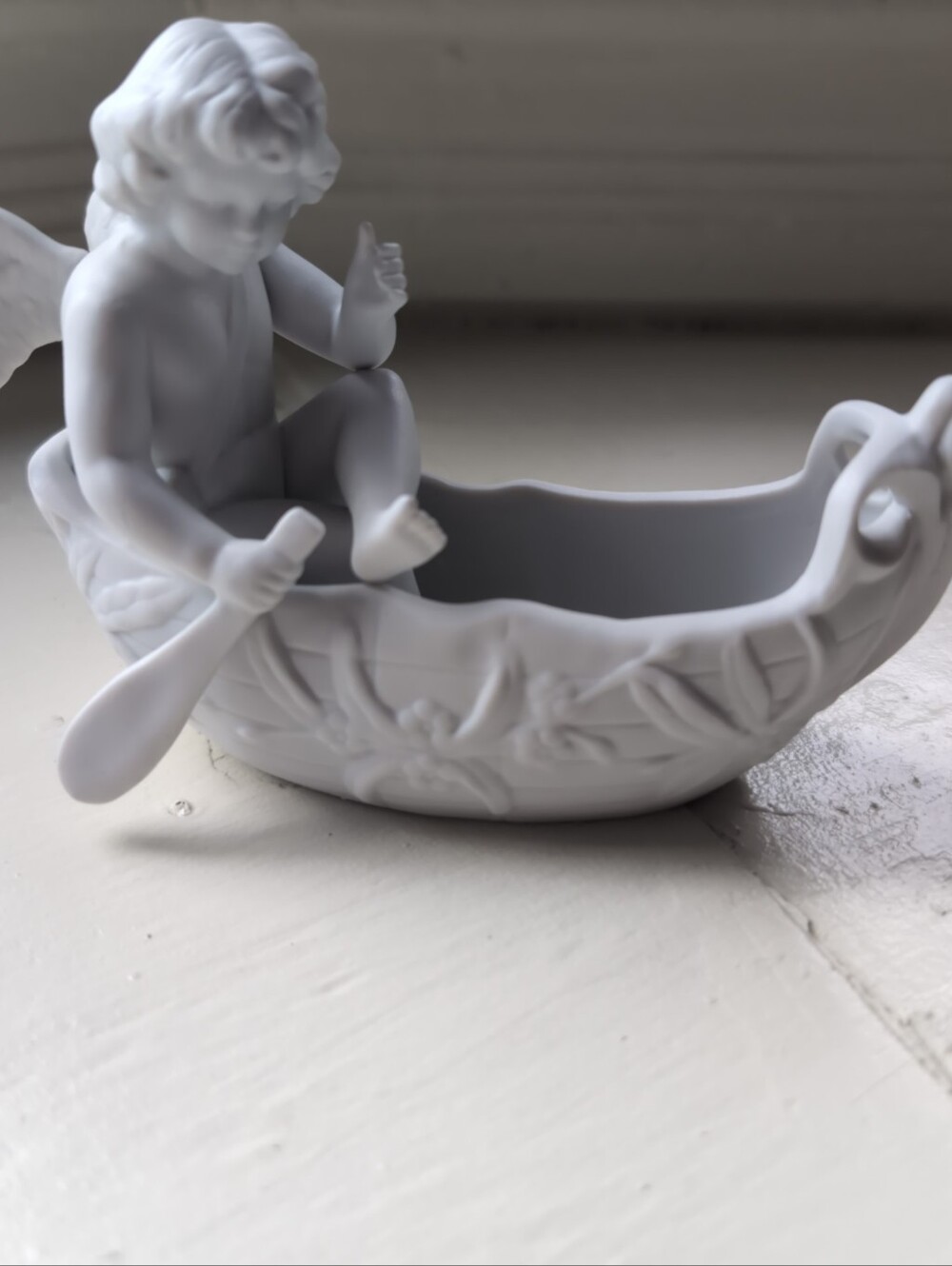 Vintage 1989 white porcelain bisque cherub in a boat